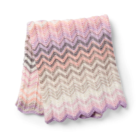 Crochet blanket pattern made with Caron Cakes self-striping yarn showing gradient stripes